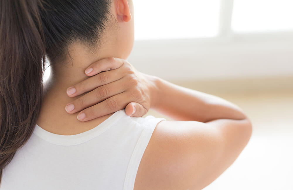 closeup of woman with neck and shoulder pain